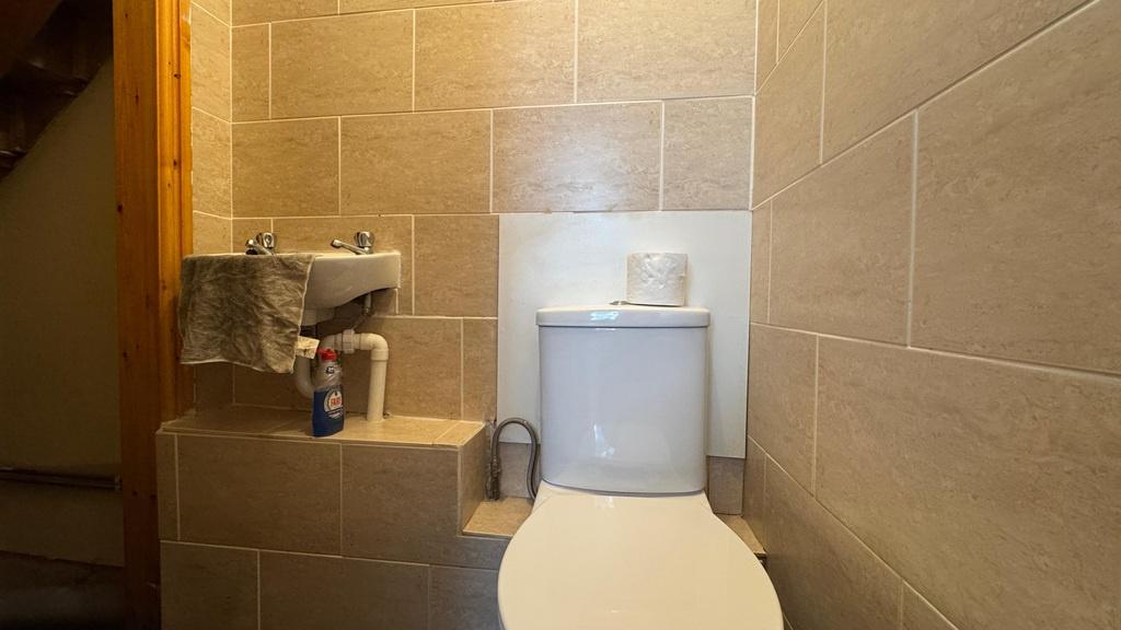 Modern tiled bathroom with white toilet...