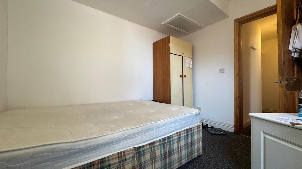 Simple furnished room with a double bed and bui...