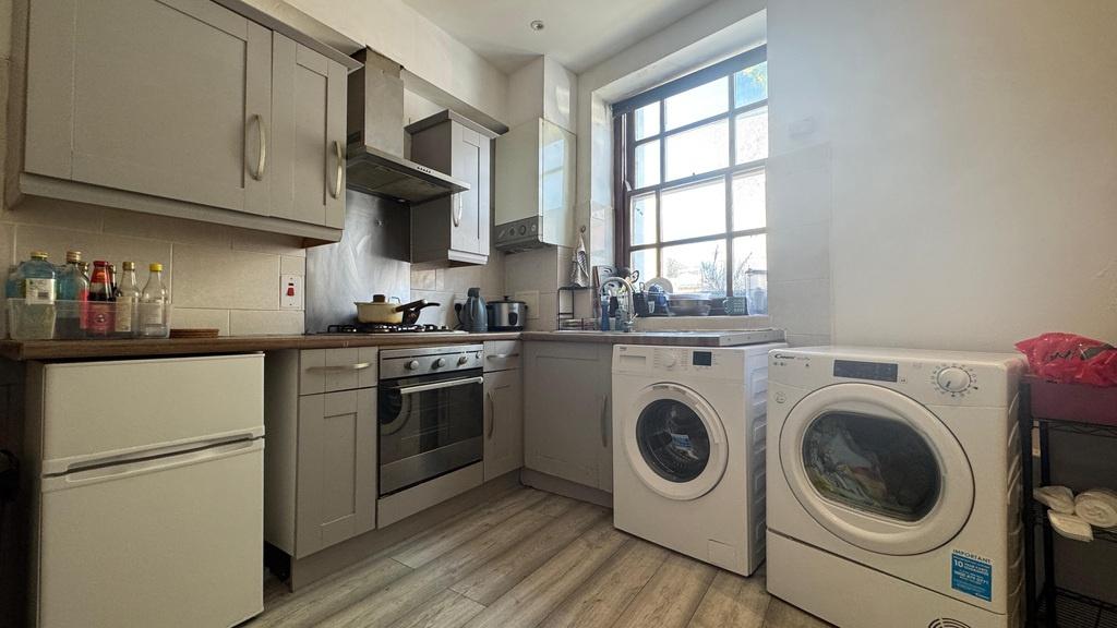 Bright kitchen with appliances and worktop spac...
