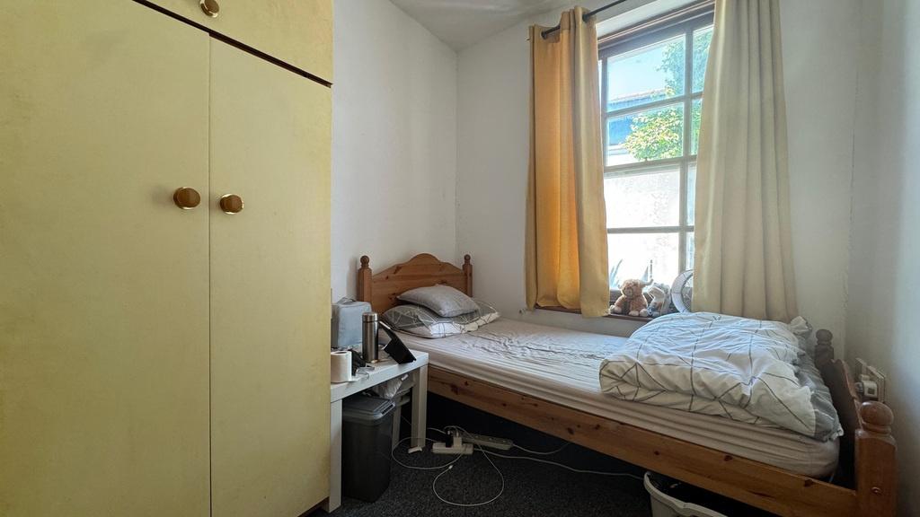 Bright bedroom with built-in wardrobe and windo...