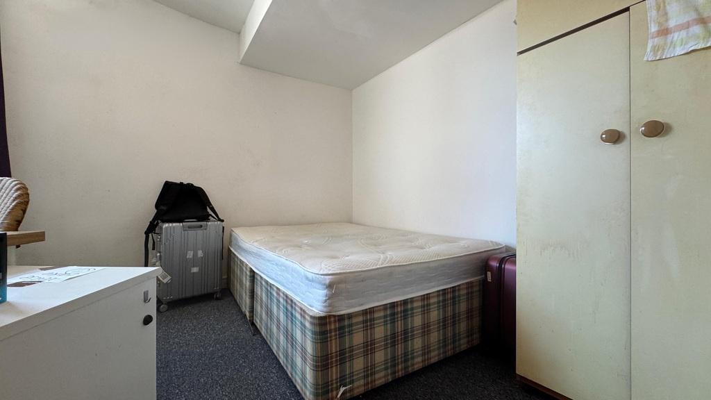 Simple single room with bed and wardrobe...