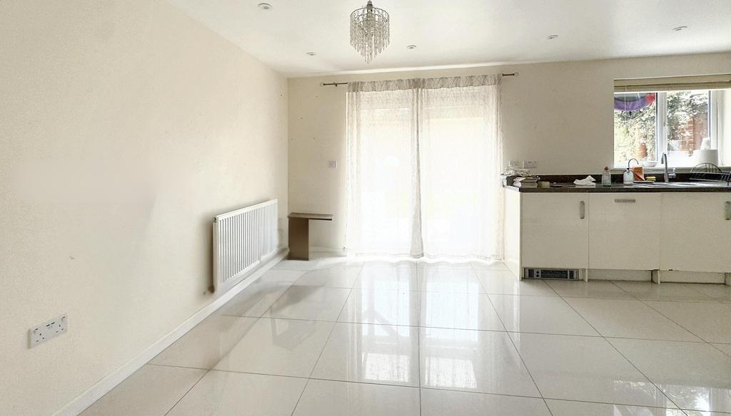 Bright open-plan living area with patio access...