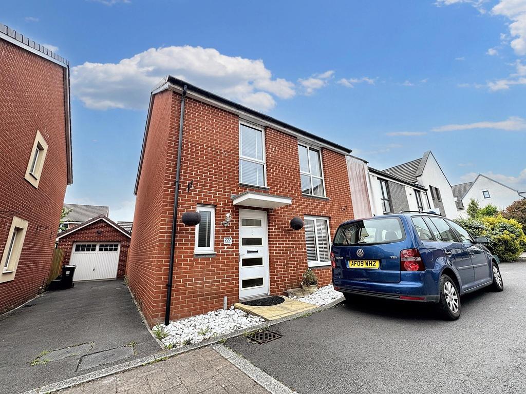Well-kept brick semi with driveway and garage...