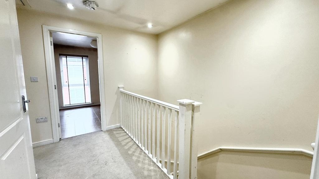 Bright carpeted landing with natural light...