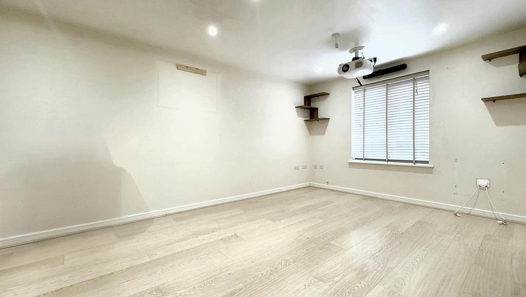 Bright, neutral living room with wood flooring...