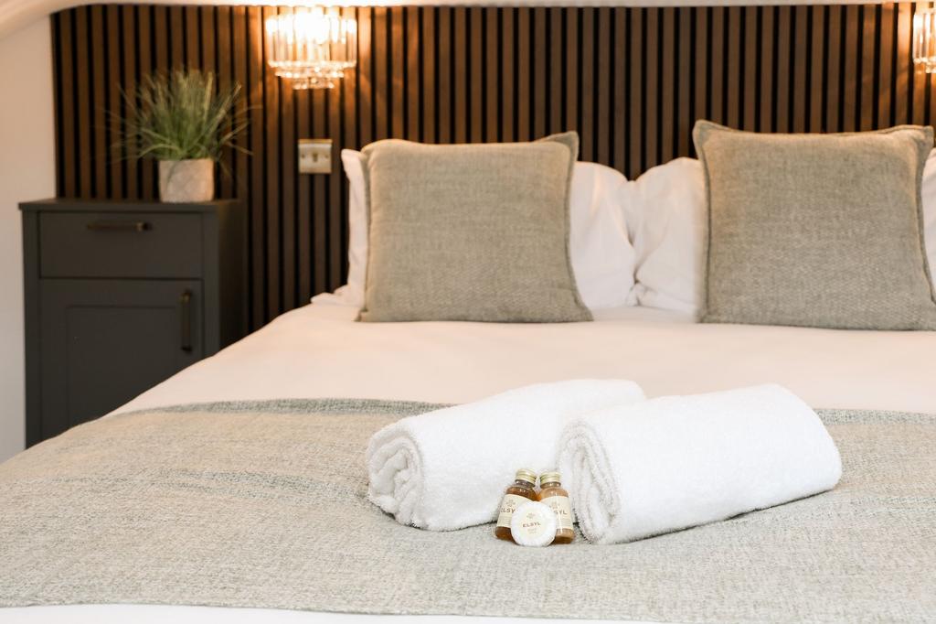 Stylish double bed with fresh towels and amenit...