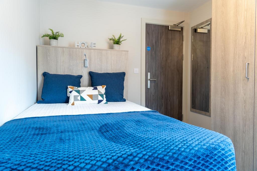 Bright double room with modern blue bedding...