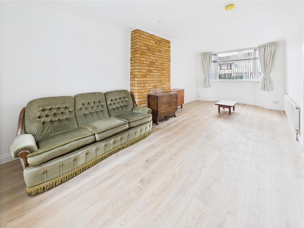 Bright living room with bay window and wooden w...