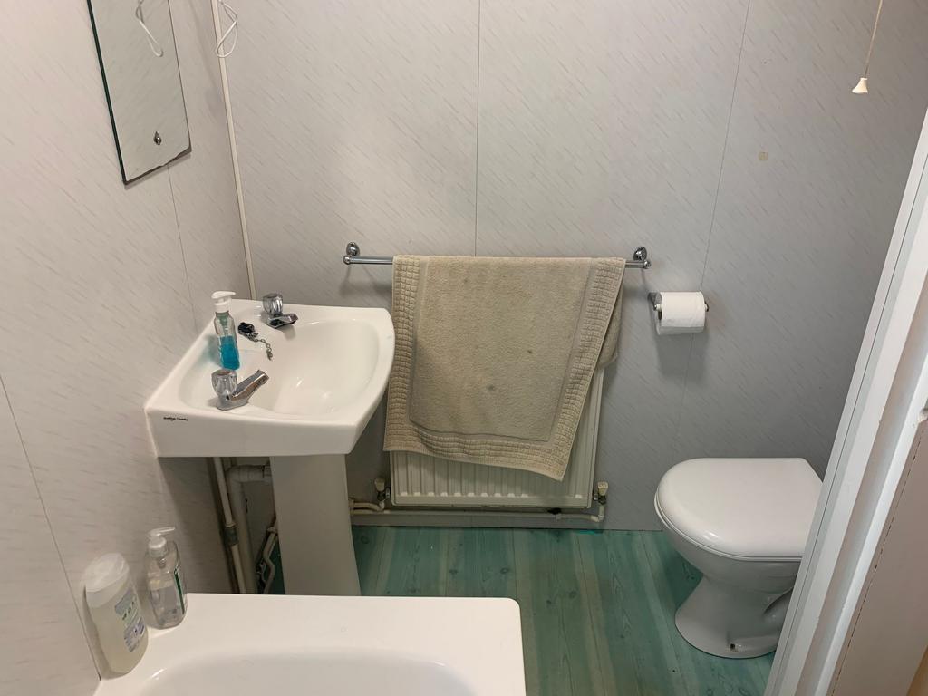 Compact, tidy bathroom with a pedestal sink, WC...