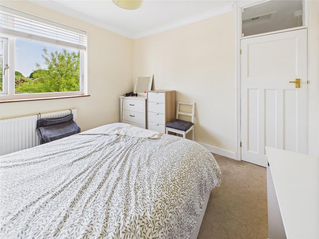 Bright bedroom with large window and storage...