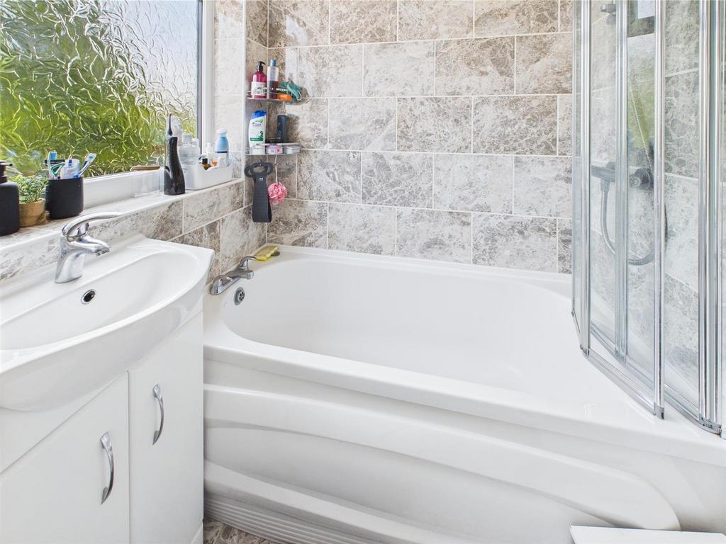 Bright modern bathroom with bathtub and vanity...