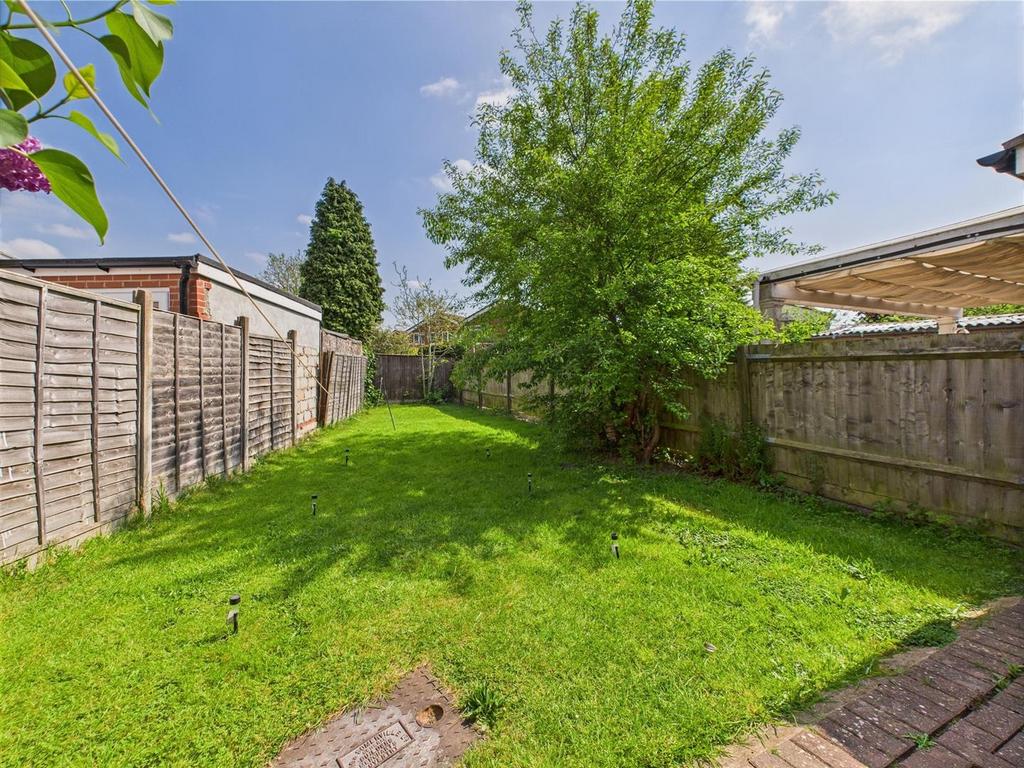 Sunny private rear garden with lawn and mature ...