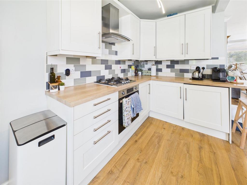 Bright modern fitted kitchen with wood flooring...