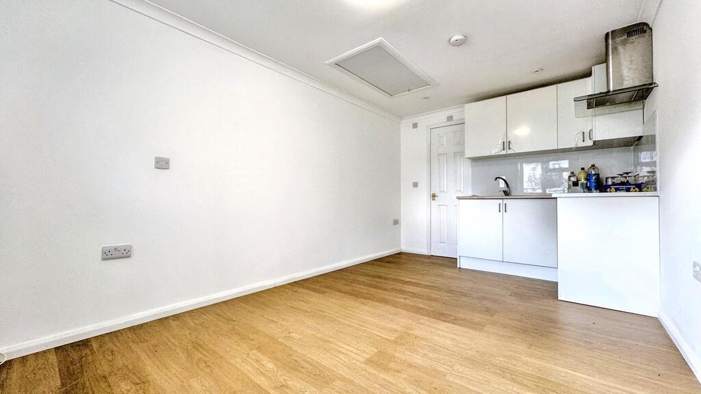 Bright open-plan living area with kitchenette...