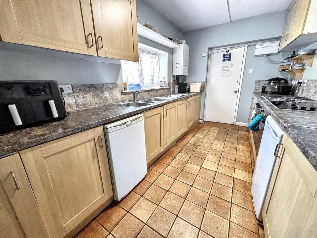 Bright galley kitchen with fitted cabinets...