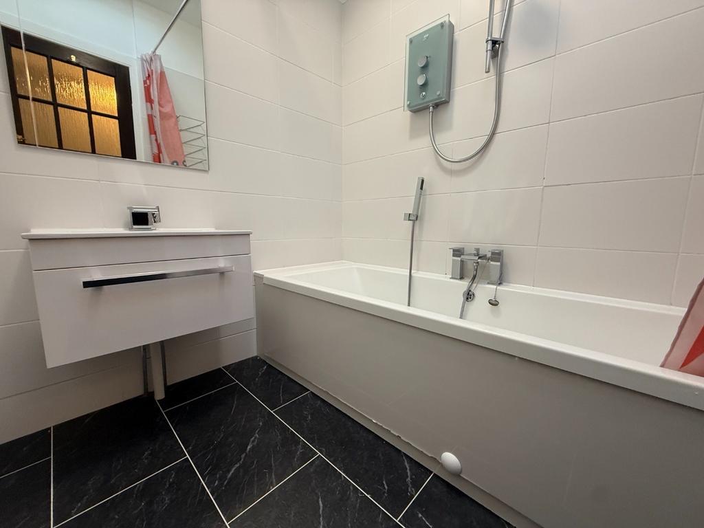 Modern white bathroom with bath and vanity...