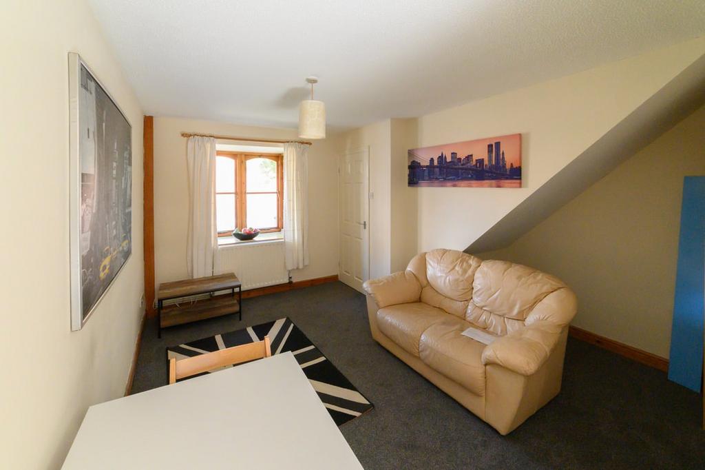 Bright, neutrally decorated living room featuri...