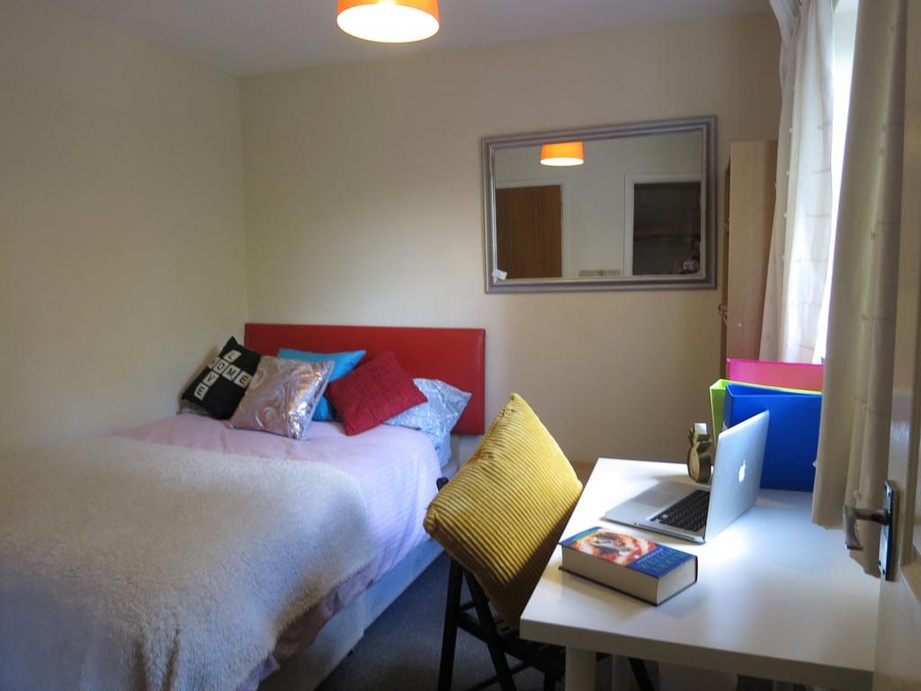 Bright, neatly presented bedroom with a comfort...