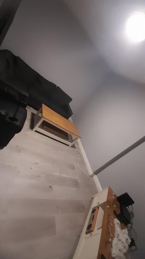 Simple, modern living area with a grey sofa, wo...