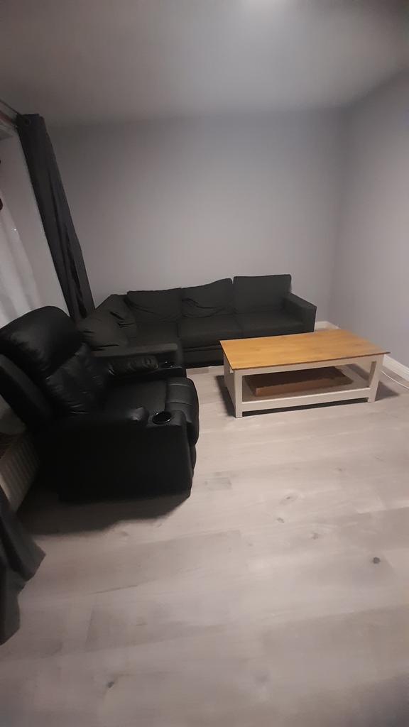 Neat, modern living area with a comfortable dar...