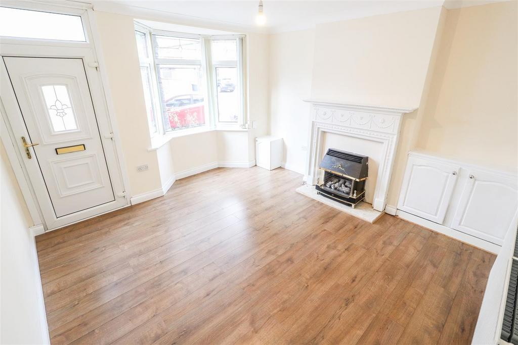 Bright living room with fireplace and bay windo...