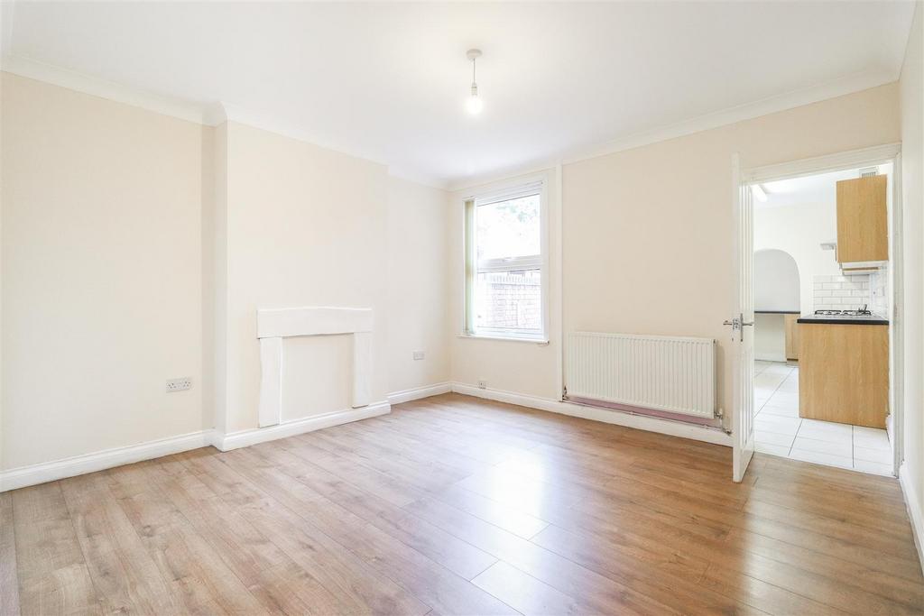 Bright living room with wooden floors and bay s...