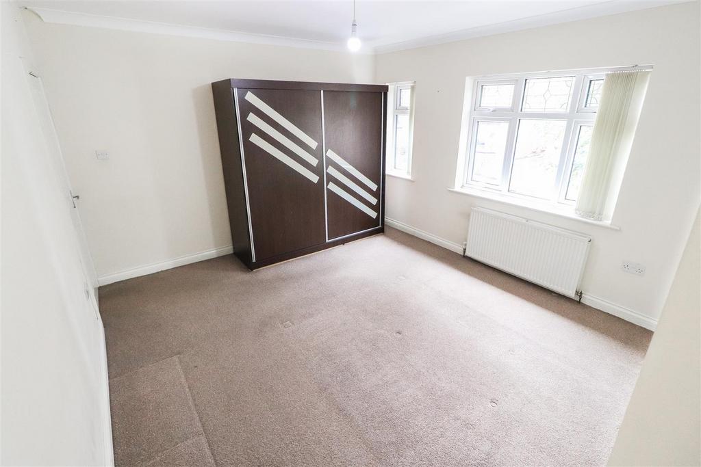 Bright double bedroom with large window and fit...