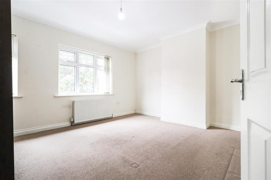 Bright bedroom with large window and neutral de...