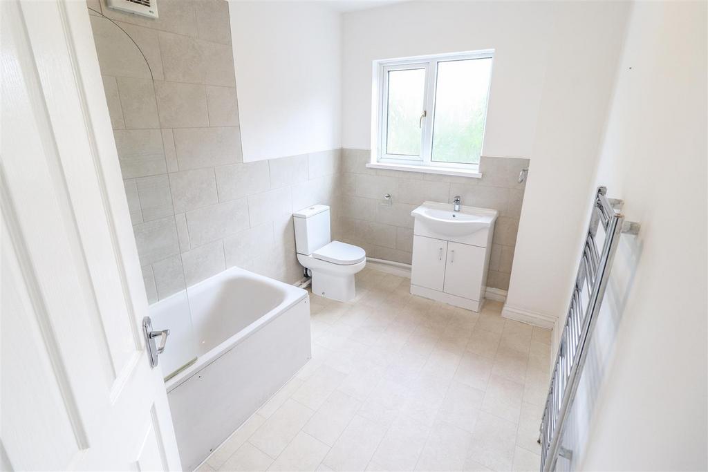Bright modern bathroom with bath and vanity...