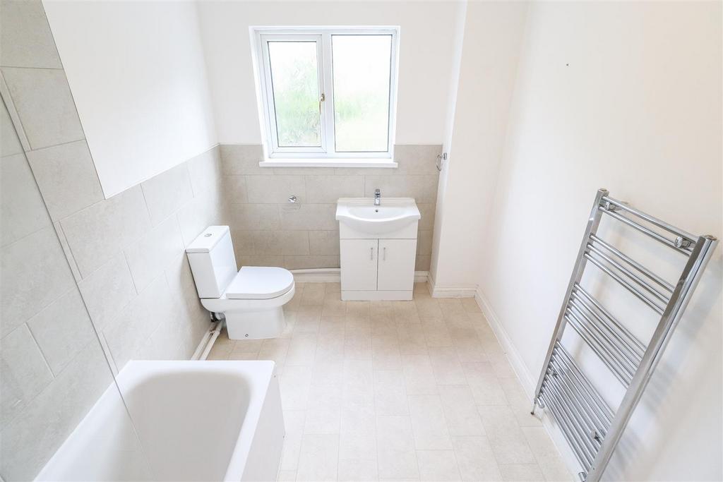 Bright modern bathroom with bath and vanity...