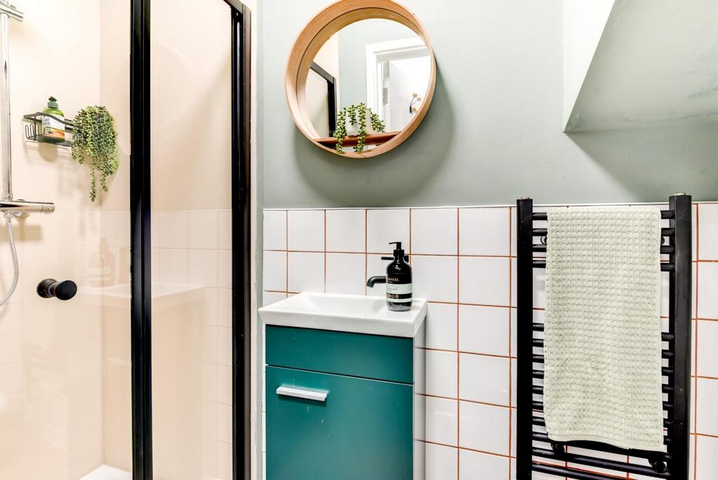Bright, modern bathroom with a framed glass sho...
