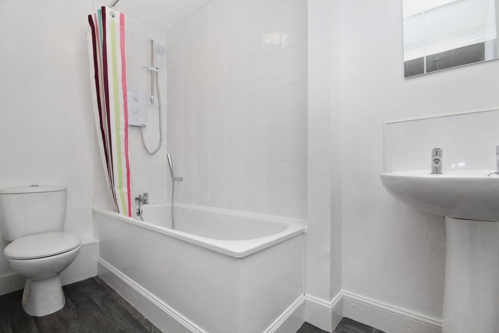 Bright modern bathroom with bath and shower...