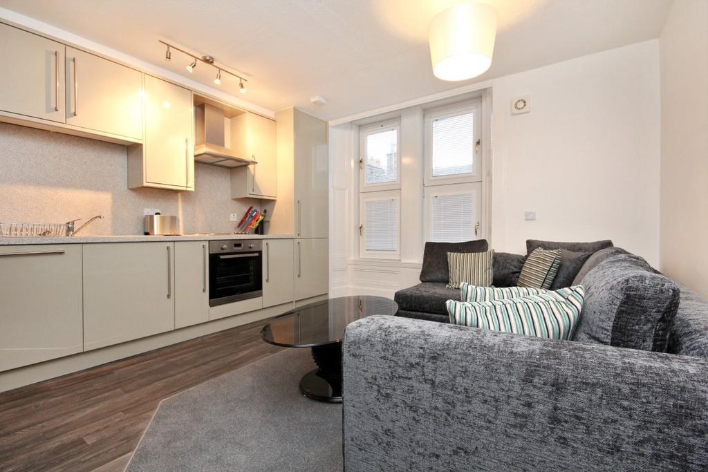 Modern open-plan lounge with kitchenette...