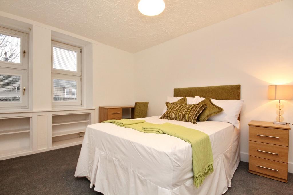 Bright bedroom with double bed and storage...