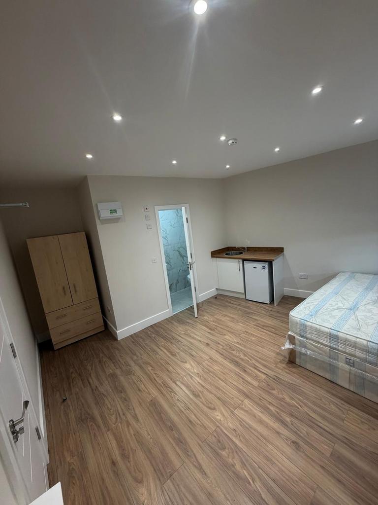 Bright modern studio with sleek wood flooring...