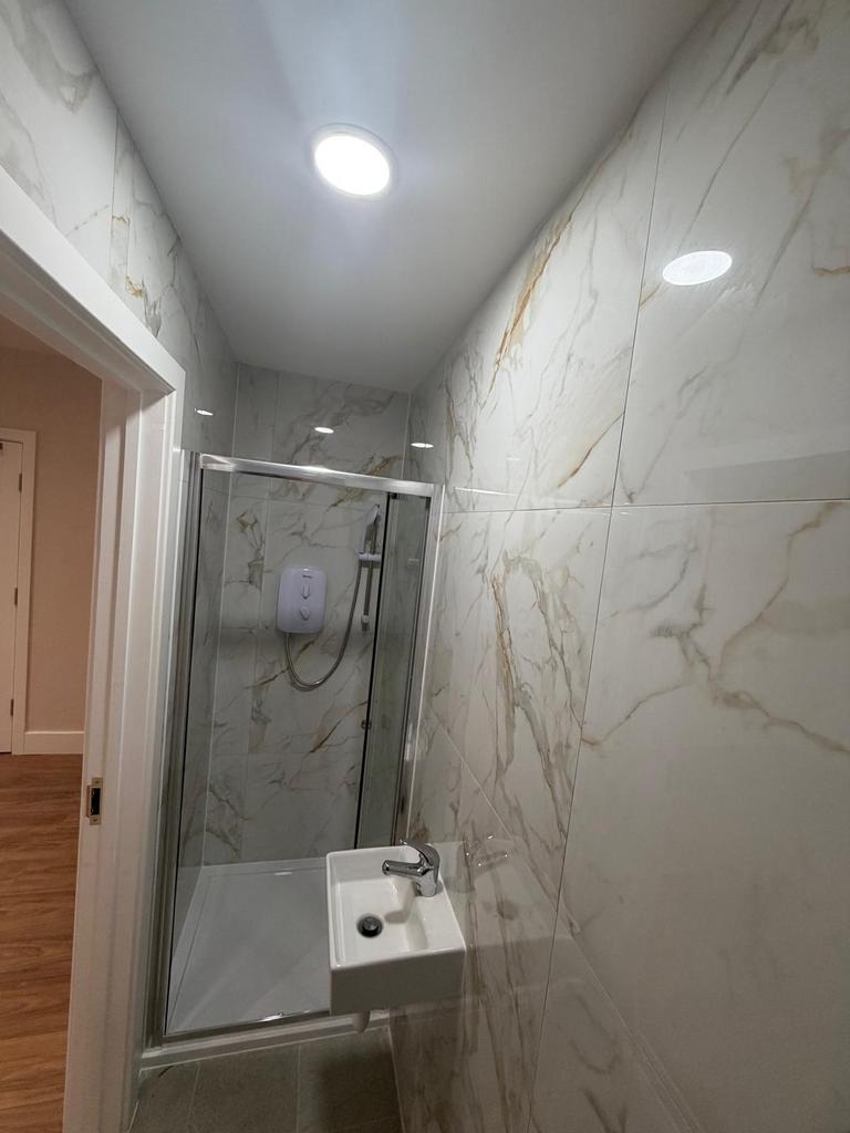 Modern shower room with luxury marble effect ti...