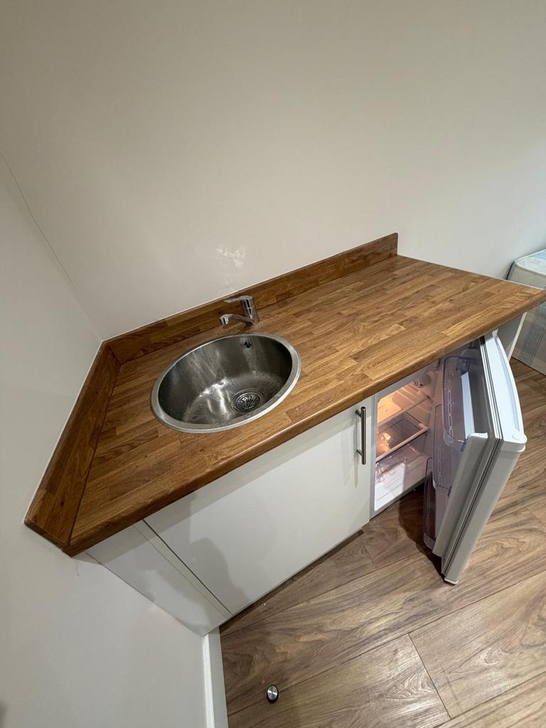 Modern kitchenette with sleek wood worktops...