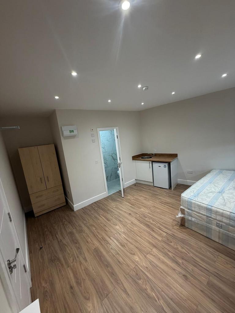 Bright studio room with sleek wooden flooring...