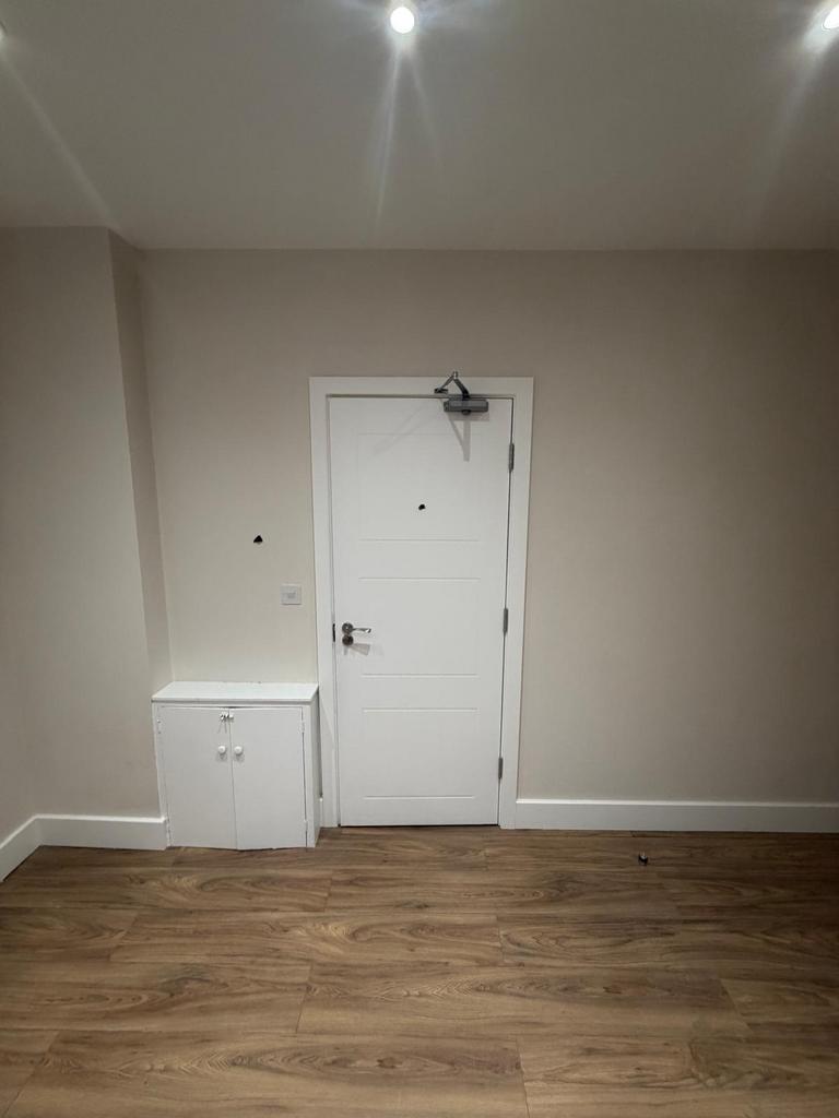 Clean hallway with modern wood-effect flooring....