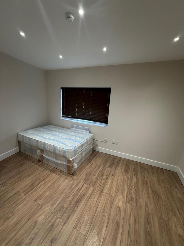 Modern double bedroom with sleek wood flooring...