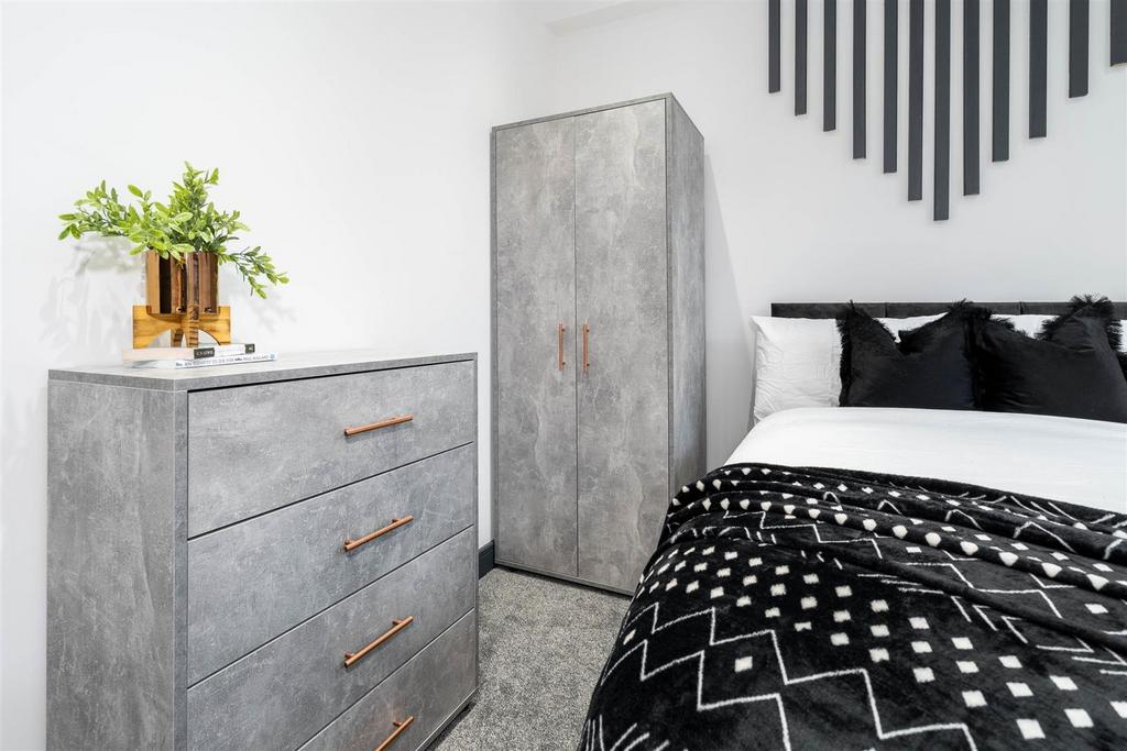 Stylish furnished bedroom with modern storage...