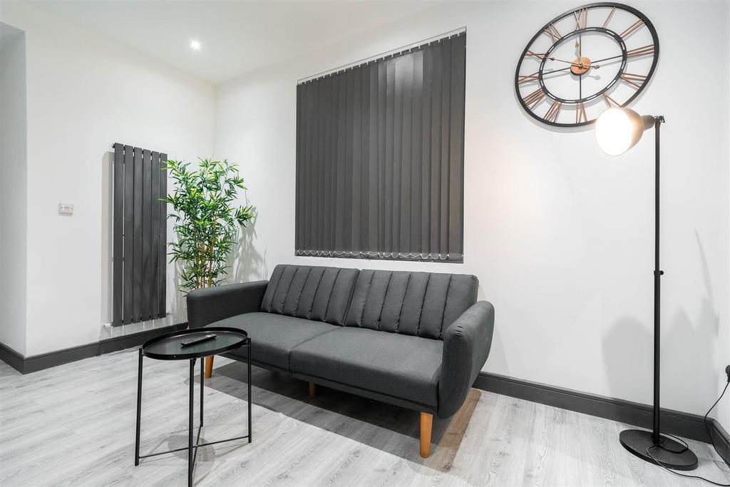 Modern lounge with sofa, lamp and wall clock...