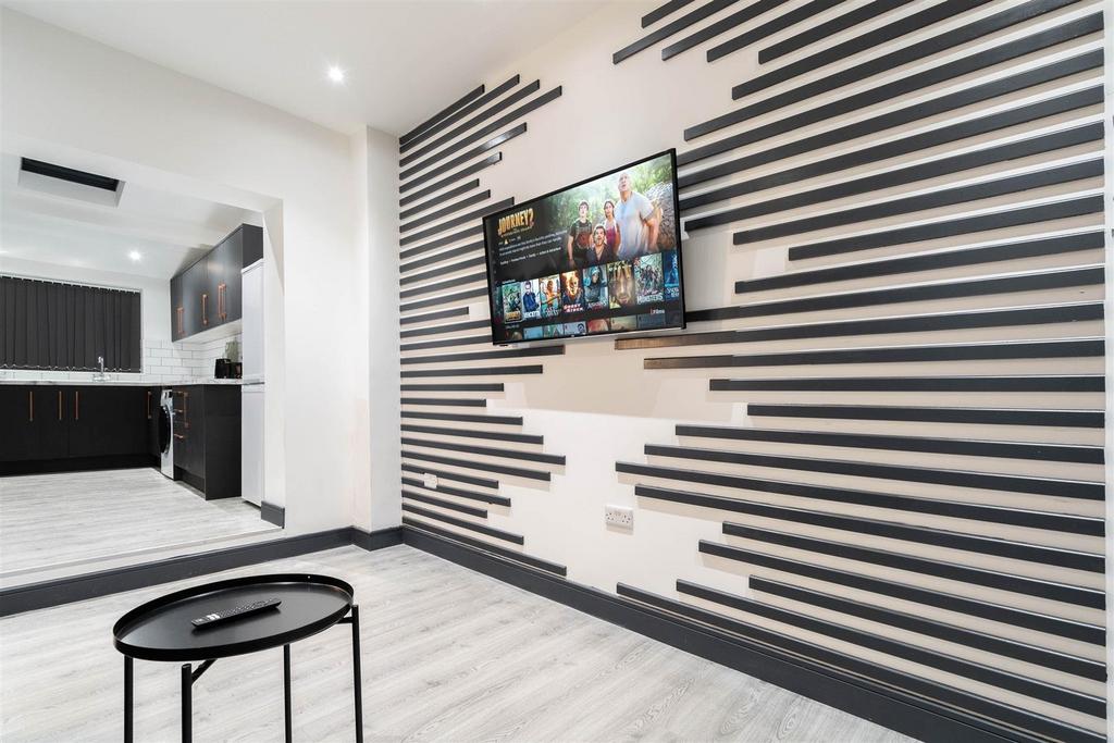 Contemporary lounge with feature wall and TV...