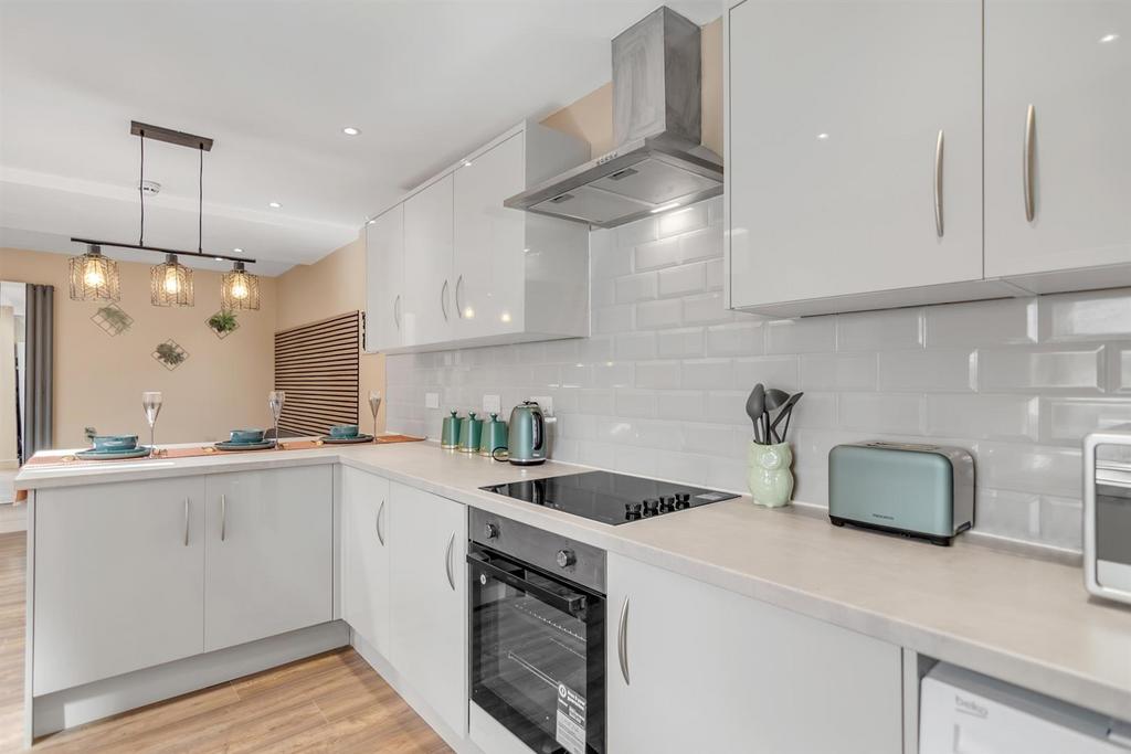 Modern fitted kitchen with light cabinets...