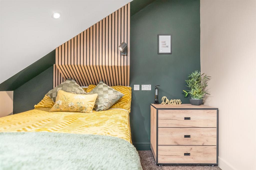 Stylish double bedroom with cosy bed and bedsid...