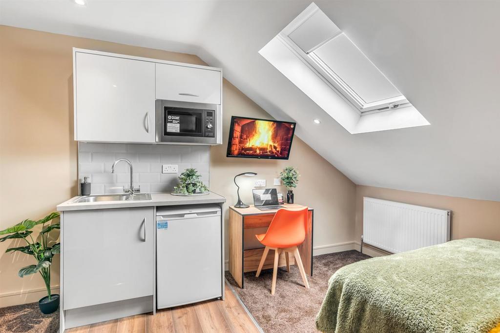 Bright attic room with kitchenette and workspac...