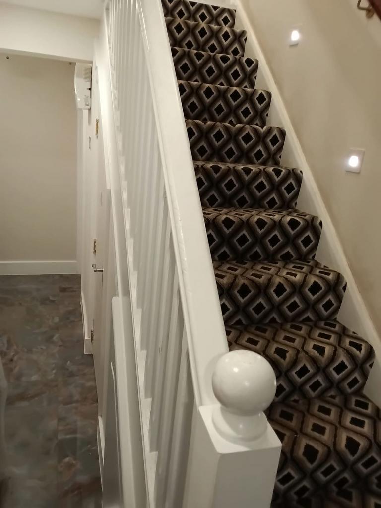 Elegant patterned stairs with bright spotlights...