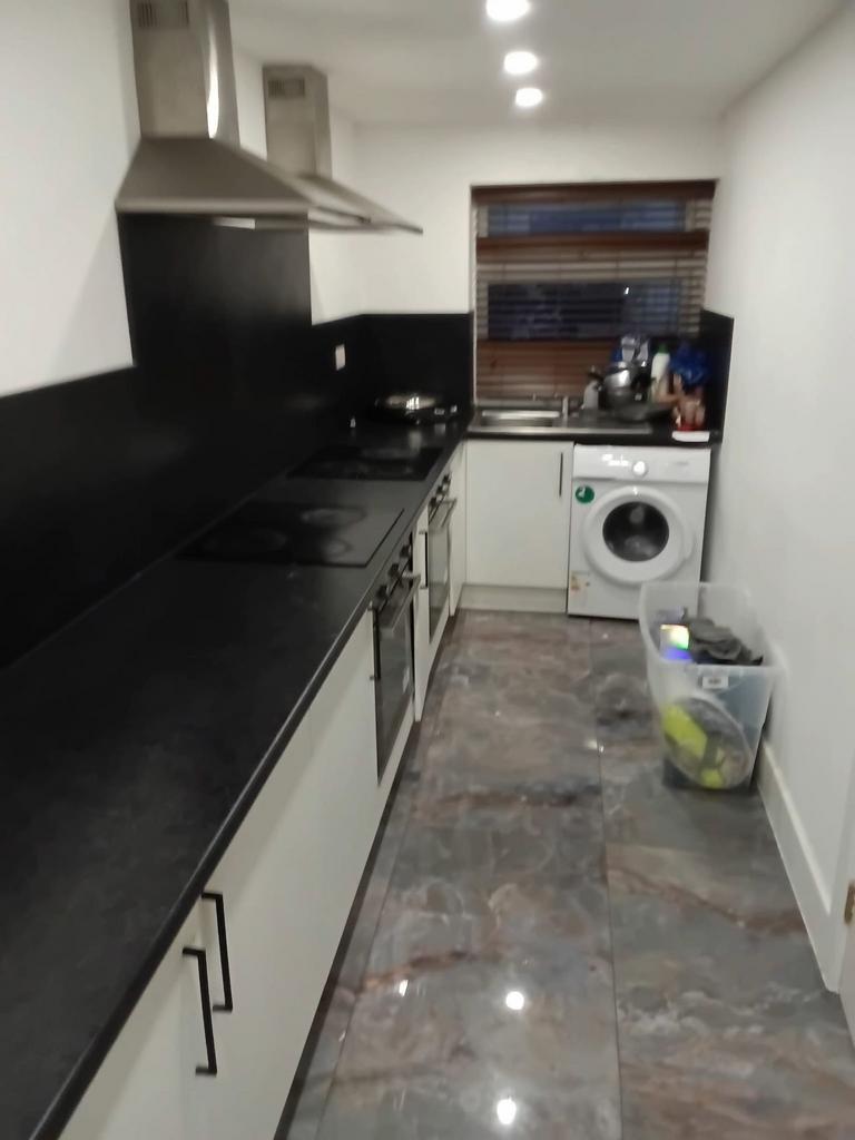 Modern kitchen with sleek dark worktops...