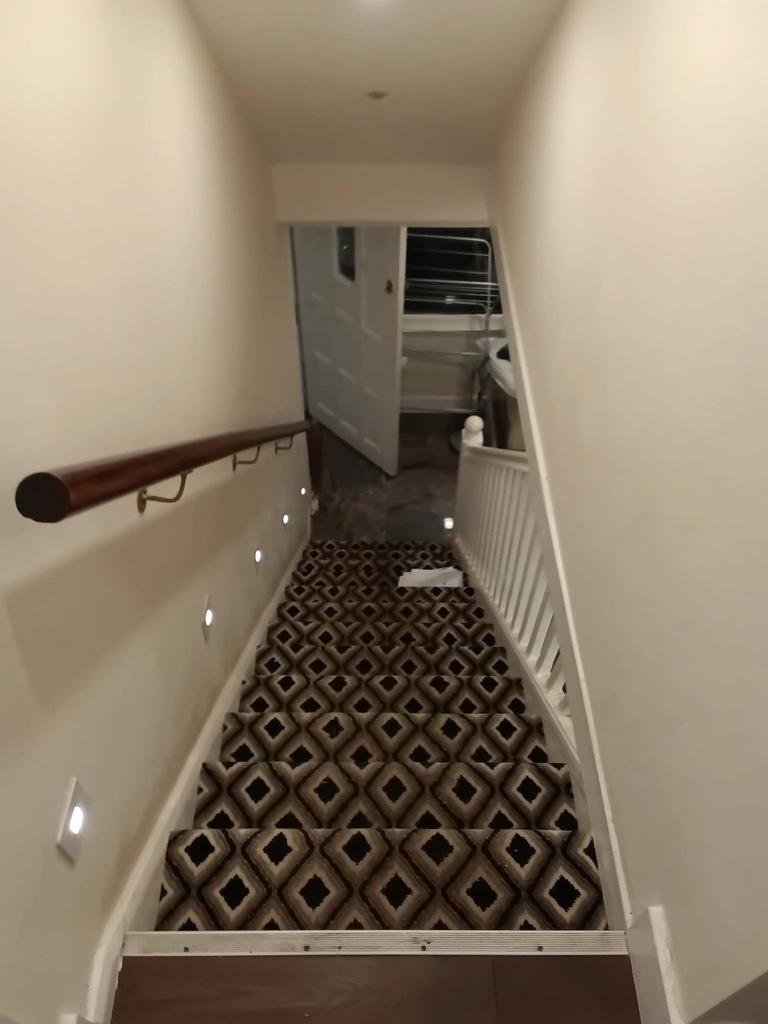 Stylish patterned carpet with modern wall light...