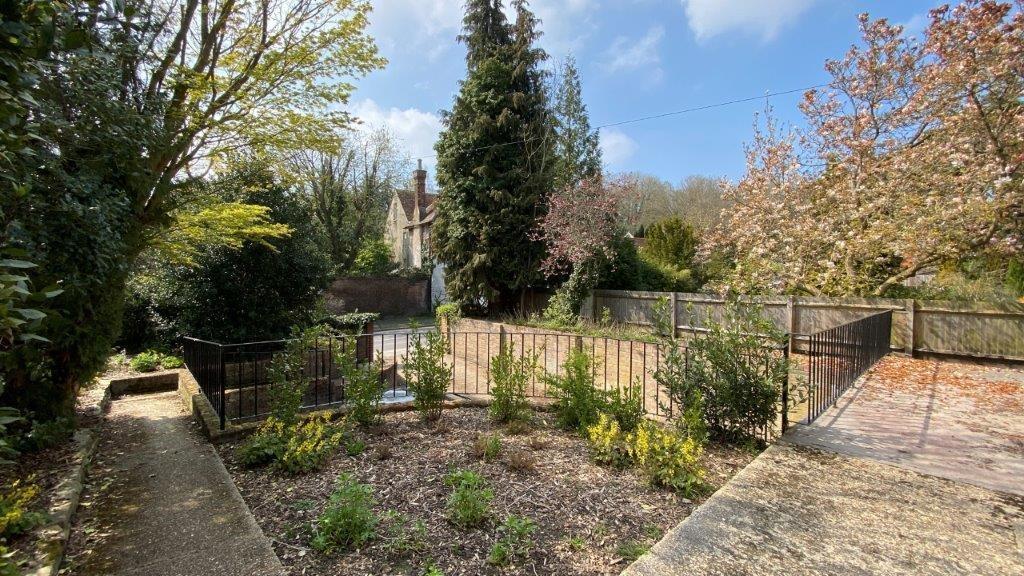 Sunny landscaped garden with mature trees...